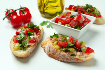 Delicious italian snacks bruschetta and ingredients on white background