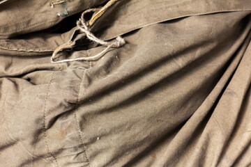 Khaki folds texture. Natural canvas material from the Second World War.