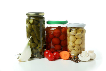 Jars of pickled vegetables isolated on white background