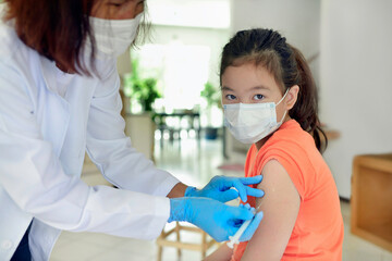 Asian child being vaccinated.Children vaccination by nurse.Medical doctor vaccinating school...