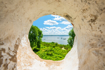 View of Nero lake through the hole of the white stone wall. Rostov Veliky, Yaroslavl region, Russia