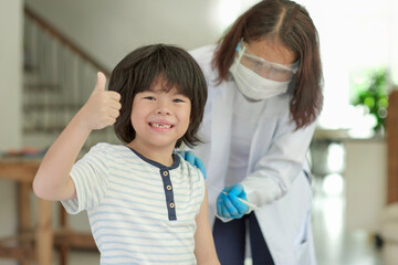 Asian child being vaccinated.Children vaccination by nurse.Medical doctor vaccinating school...