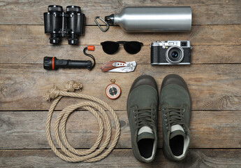 Flat lay composition with different safari accessories on wooden background © New Africa