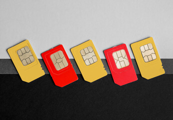 Different SIM cards on color background, flat lay