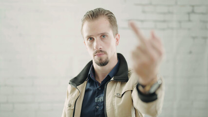 Confident man show middle finger towards the camera