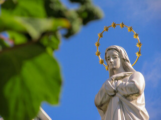Monument to the Mother of God with a golden halo over the naked