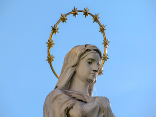 Monument to the Mother of God with a golden halo over the naked
