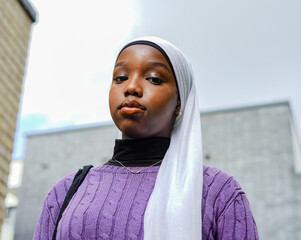 Portrait of young woman wearing hijab outdoors
