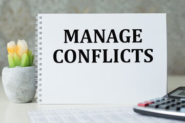The text of MANAGE CONFLICTS in the notebook top view side by side calculator and financial statements