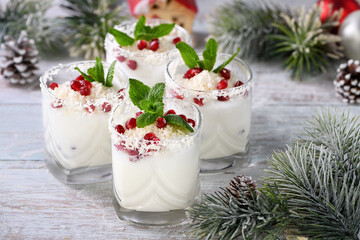 White Christmas mojito made from liqueur, tequila, coconut milk with pomegranate seeds, coconut...