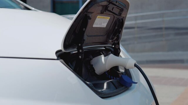 The process of connecting the electric car to the charger. Close-up view