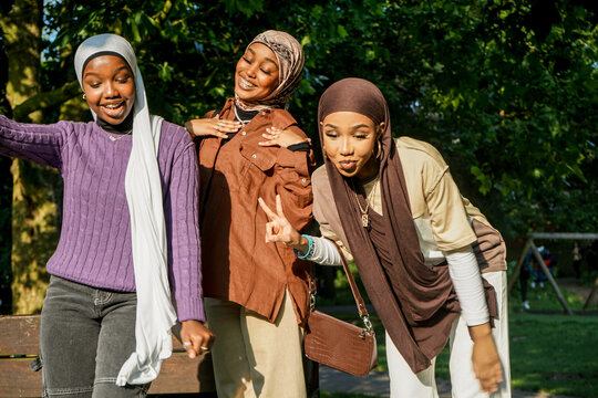 Portrait of three young women wearing hijabs in park