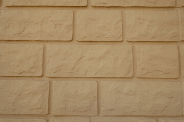 Obraz premium Background - yellow brick veneer wall (front view)