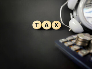 Tax-filling concept - Tax word with dark vintage background. Stock photo.