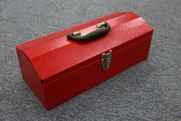 A red tool box that contains a lot of tools, this box makes it easier for workers to store their tools and carry them when needed, and can reduce work accidents