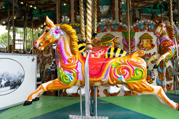 Fototapeta na wymiar London, U.K., July 22,2021: Carousel horse, having fun, merry go ride at London Zoo park