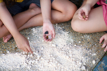 Child's hand holding crystal rock.Mining Science activity fot children.Exploration of minerals for kids.Discovery of rocks.