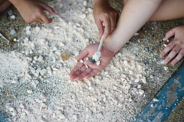 Child's hand holding crystal rock.Mining Science activity fot children.Exploration of minerals for...