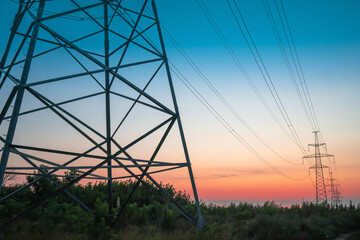 Electricity pole with silhouette sunset sky, Electricity pylon with shadow of tree in dawn time, Electricity power transmission line on sunset with copy space