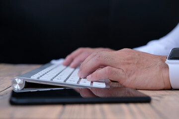 person typing on a keyboard, office equipment and keyboard on table background 