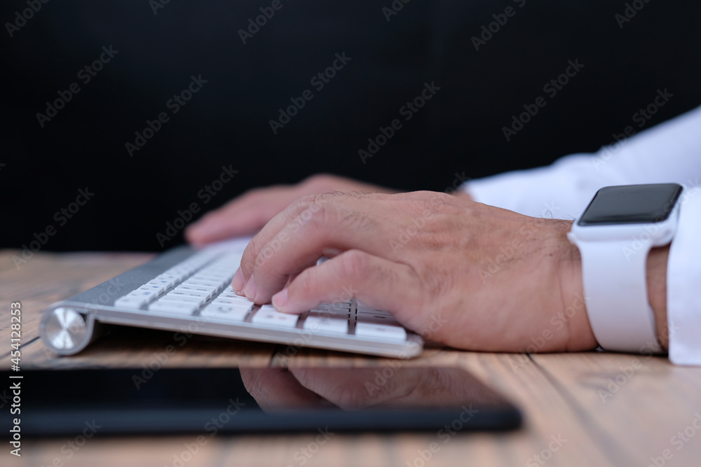 Poster person typing on a keyboard, office equipment and keyboard on table background