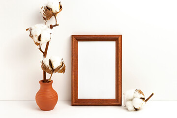 Mockup photo frame and vase with dried branch of cotton