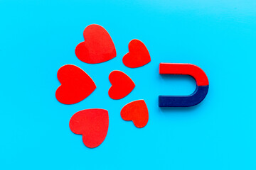 Magnetic love concept. Horseshoe magnet with heart shapes