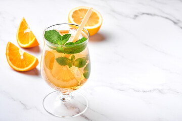 Traditional iced tea with lemon and ice in tall glasses on marble table background Iced tea with lemon. Selective focus. Refreshment cold summer drink.