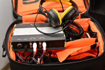 A dj back ready to travel for making dj set with serato, headphones, and some stuff in it 