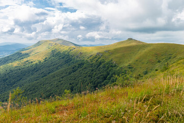 Verkhovyna Watershed Range, Pikui Mountain. Carpathian mountains with grassy slopes and rocks on Pikuy mount. Beautiful mountain landscape in summer
