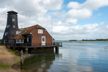 Obraz premium old historic mill at Langstone Harbour&nbsp;Hampshire England reflecting in the sea on a bright summer day