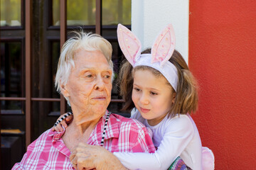 great-grandmother and her granddaughter in a bunny costume