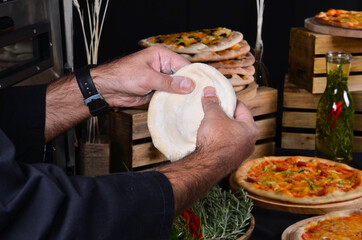 Pizza maker's hands kneading the dough. The cook makes pizza.