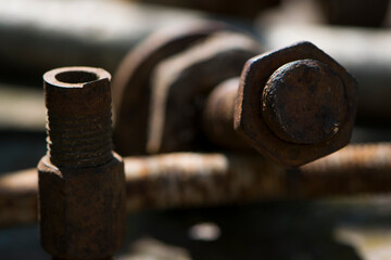 old rusty bolt, iron rod with screw threads. Rusted mechanical components. threaded bolt and nut. dismantling concept, difficult to unscrew, non-removable. selective focus, close-up, macro