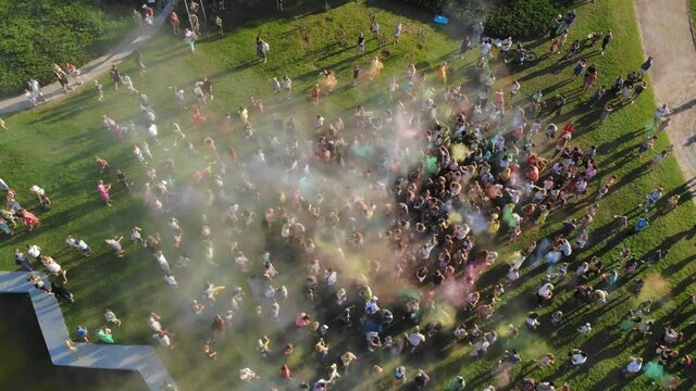 powder paints. aero. aerial top view. Many people having fun, enjoying of throwing with dry color powder during festival of colors, in the park . summer.