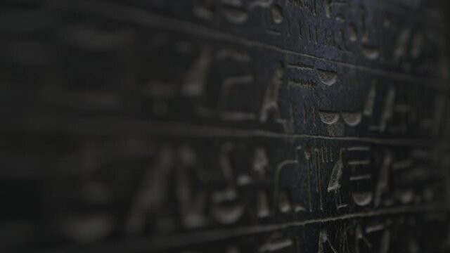 Macro shot moving down wall with ancient Egyptian hieroglyphics written