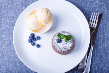 Lava cake - chocolate fondant cake with vanilla ice cream, blueberries and mint. Traditional French...