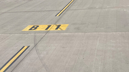 taxiway yellow line B11 on airport runway for gate direction
