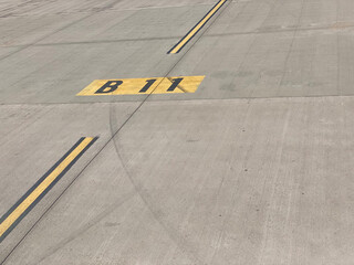 taxiway yellow line B11 on airport runway for gate direction