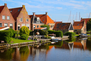 Fototapeta na wymiar Gable architecture of typical Dutch residential homes along canal (Hindeloopen, Netherlands)