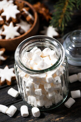 jar with sweet marshmallows and Christmas decorations, top view