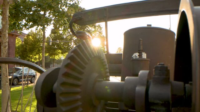 Sun leaking behind an vintage car, pull out shot