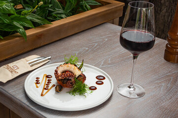 grilled octopus with a glass of red wine