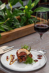 grilled octopus with a glass of red wine