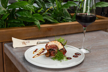 grilled octopus with a glass of red wine