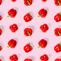 seamless pattern of bulgarian red pepper on pink background. paprika wallpaper, sweet pepper print pattern, top view, flat layout, isolated.