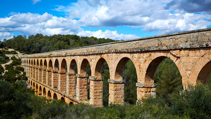 Fototapeta na wymiar The Ferreres Aqueduct, also Pont del Diable or Devil Bridge, an ancient bridge, part of the Roman aqueduct built to supply water to the ancient city of Tarraco, today Tarragona in Catalonia, Spain.