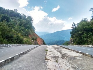 the appearance of two highways with a background of mountains and blue sky
