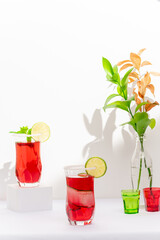 red cocktail glass made of vodka and sparkling wine on white background