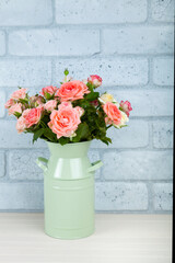Bouquet of pink roses in a green vase